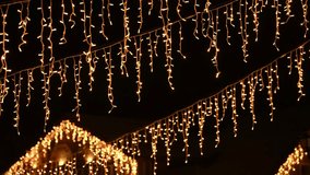 Blurred flickering lights of hanging garlands for New Year christmas street decorations at night, merry Christmas and happy New Year mood with defocused twinkling lights bokeh - Powered by Shutterstock - Get 15% off with code: PIKWIZARD15