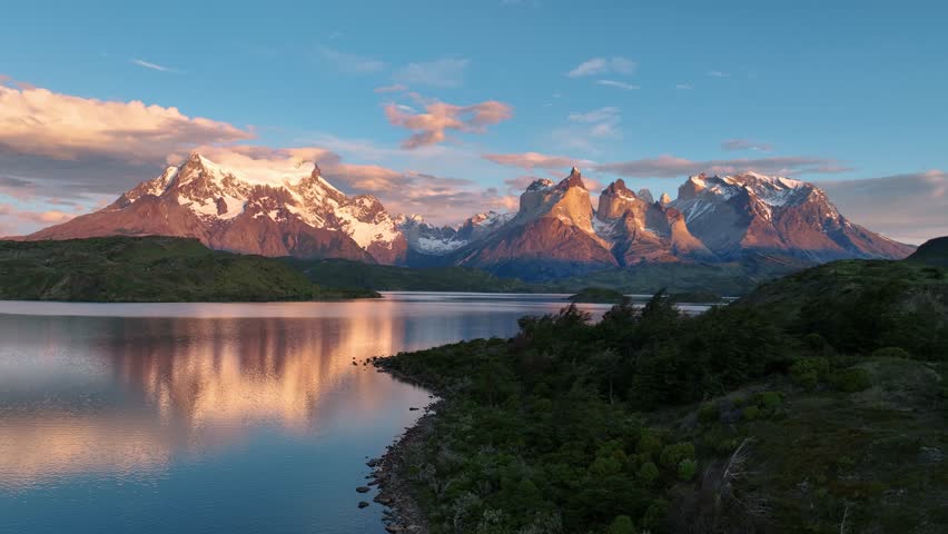 Aerial view of snow-capped mountains and lake at torres del paine, patagonia, chile.