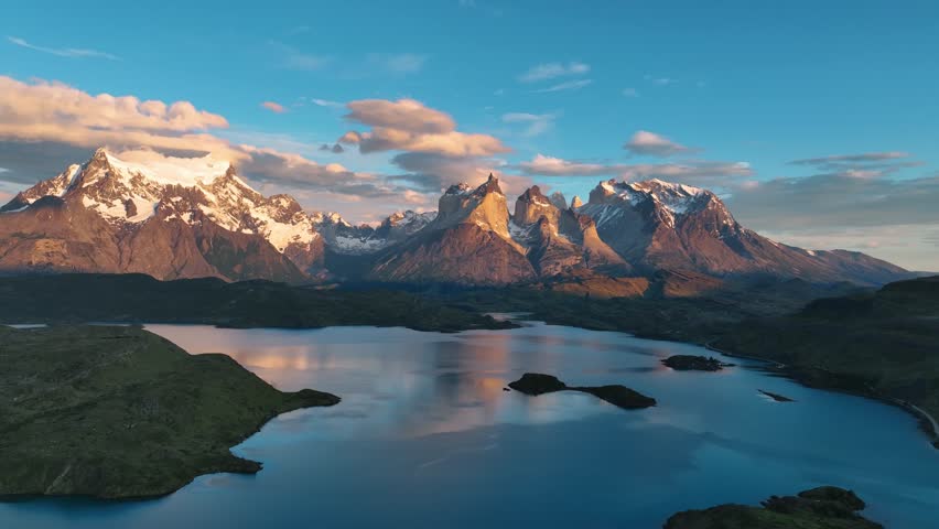 Aerial view of Torres del Paine in sunset with snowcapped peaks and pristine lake, Patagonia, Chile.