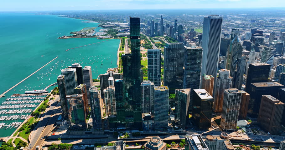 Breath-taking scenery of the waterfront of Lake Michigan in Chicago, Illinois, the USA. Sunny day footage above the gorgeous metropolis and waterscape.