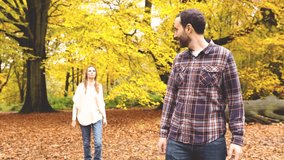 Happy couple hugging and playing piggyback ride in the wood with autumn foliage colors - Lifestyle, love and nature concepts - Powered by Shutterstock - Get 15% off with code: PIKWIZARD15
