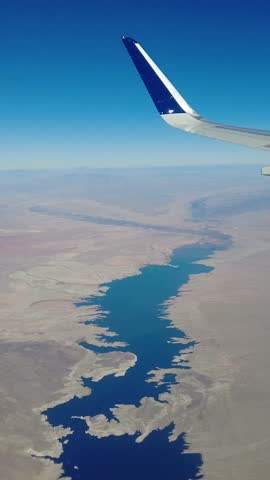 Plane window view flying over lake mead nevada arizona border desert usa deserted remote location
