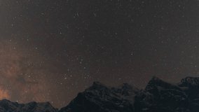 4K Night Lapse shot of Milky Way rising above the snowy Himalayan mountain peaks during the full moon night as seen from Khangsar Village in Lahaul, Himachal Pradesh, India. Night lapse background. - Powered by Shutterstock - Get 15% off with code: PIKWIZARD15