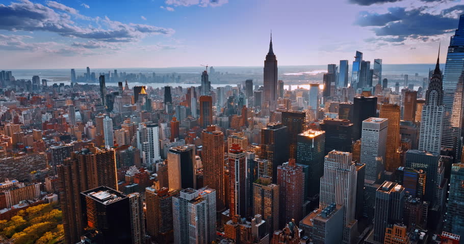 Urban scenery of New York in the light of setting sun. Amazing metropolis from aerial perspective.