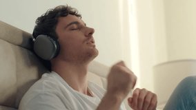 Caucasian European man listening music headphones technology sing home bedroom earphones gadget weekend digital leisure relaxation device sound tune gesture song rhythm lifestyle mp3. 3D Illustration - Powered by Shutterstock - Get 15% off with code: PIKWIZARD15