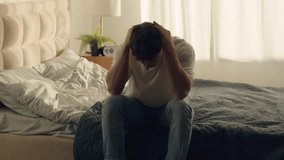 Caucasian man sitting on bed holding head grief pain crisis separation fatigue headache burnout bedroom guy male emotional stress tired exhaustion sadness anxiety distraught problems overworked loss - Powered by Shutterstock - Get 15% off with code: PIKWIZARD15