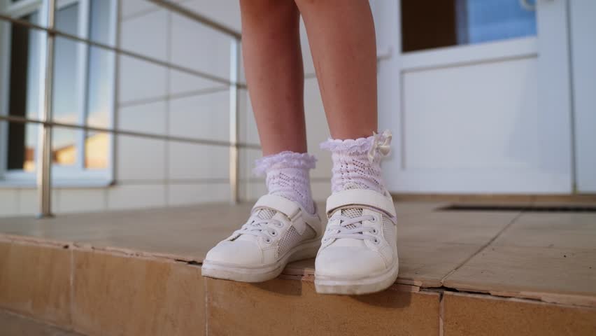 girl child kid leg, schoolgirl legs steps going down staircase sneakers socks shoes walking descending movement stairs, footwear young girl white socks white shoes kid steps down motion stairway