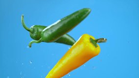 Yellow and green chili bell peppers launched in air with water droplets, vegetables for cooking. High quality cinematic studio commercial super slow motion 1000fps fresh vegetables moving up and down. - Powered by Shutterstock - Get 15% off with code: PIKWIZARD15