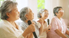 Group of Happy Asian senior women friends singing karaoke with dancing together in living room. Elderly retired people enjoy and fun indoor lifestyle spending time together with home entertainment. - Powered by Shutterstock - Get 15% off with code: PIKWIZARD15