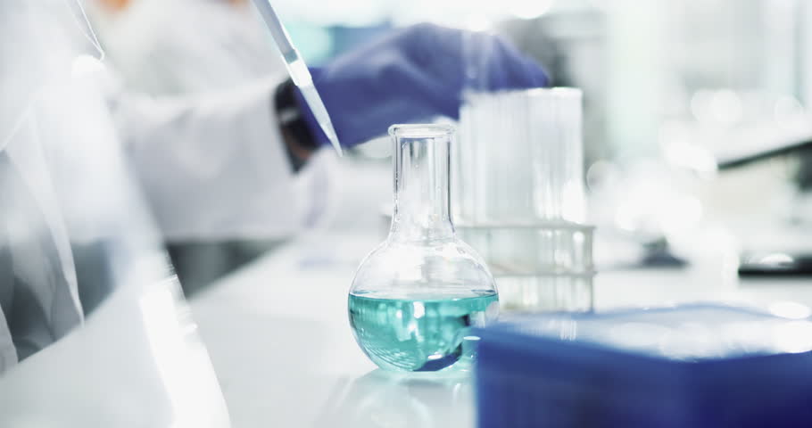 Chemical, person and science beaker in laboratory, experimental chemistry and pipette for liquid transfer. Investigation, cure innovation and pharmaceutical development, research and scientist