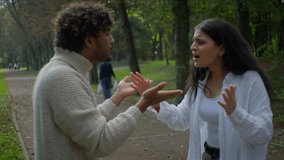Tense angry married multiethnic couple family Hispanic woman female Arabian man male arguing screaming yell. Stressed wife husband disputing relationship conflict breakup divorce quarrel park outdoors - Powered by Shutterstock - Get 15% off with code: PIKWIZARD15
