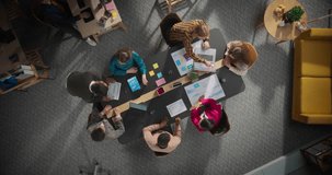 Diverse Team Collaborating with AI Tools in a Modern Office Meeting Room. Top Down View Highlighting Dynamic Interaction and Advanced Technology Integration with Holographic Interfaces - Powered by Shutterstock - Get 15% off with code: PIKWIZARD15