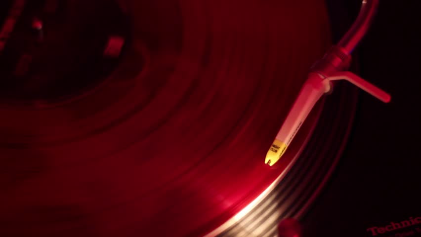Music record close-up, turntable with stylus playing in nightclub