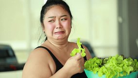 enjoying tasty vegetable salad. beautiful young chubby overweight woman wearing sporty fitness clothes doing exercise indoors at gym fitness sport club, body and health care - Powered by Shutterstock - Get 15% off with code: PIKWIZARD15