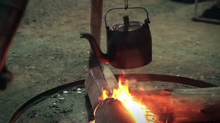 Old Rustic Kettle Hanging Over Campfire Flames at Night in Outdoor Camp Scene - 4K