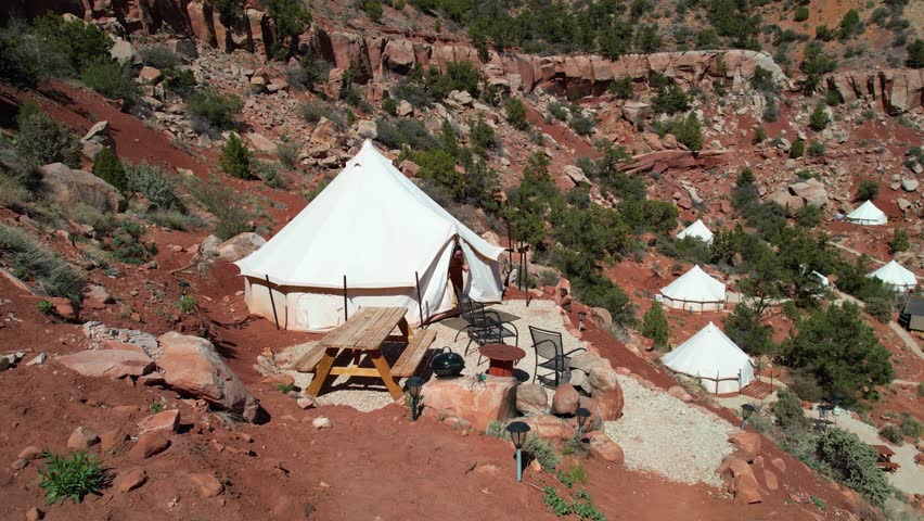Drone Shot of Young Woman Going Out From Yurt Tent and Enjoying in Landscape of Zion National Park, Utah USA