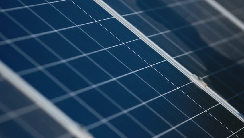 Close-up of a woman's hand checking solar panels, maintenance and engineering stability. Business woman examining completion of work or checking quality of renewable energy.