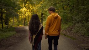 Two friends or a couple talking and enjoying a relaxed walk in nature. Lifestyle slow motion follow shot
 - Powered by Shutterstock - Get 15% off with code: PIKWIZARD15
