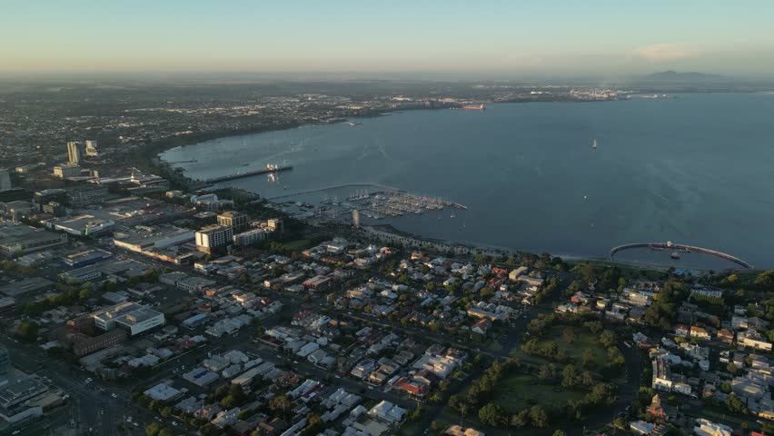 Geelong port city at sunset, Corio Bay close to Melbourne, Victoria state in Australia. Aerial forward