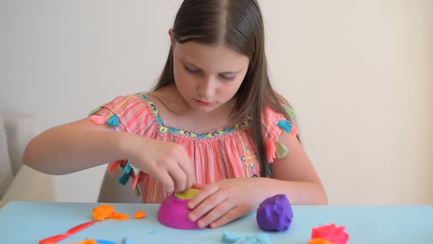 Colorful clay. Child's hands playing with colorful clay. Plasticine. play dough.