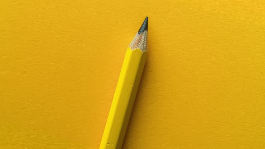 Sharp Yellow Pencil on Vibrant Yellow Background