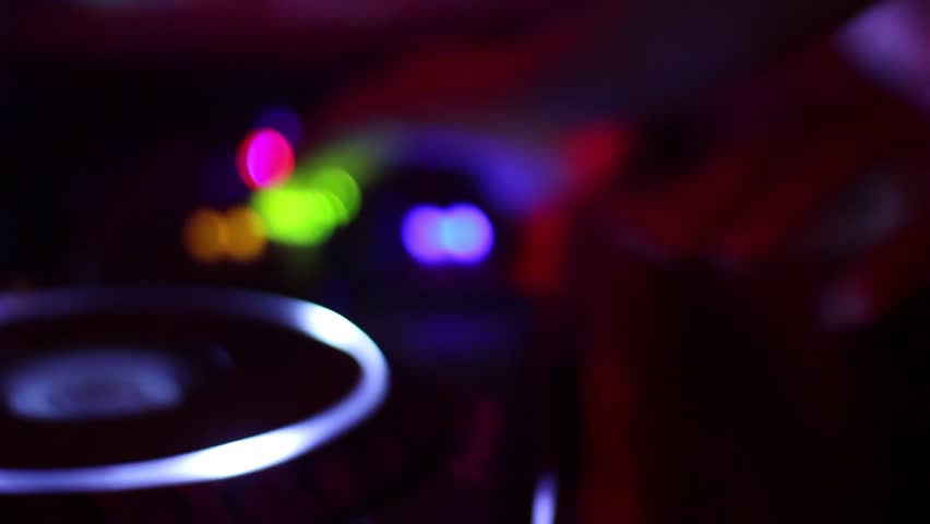 Female dj hands crossed tweaking mixer controls, playing music in nightclub