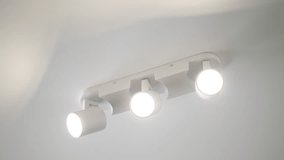Loft spot track light in slow motion. Electric Ceiling Lighting. White spotlight. Chandelier on the ceiling - Powered by Shutterstock - Get 15% off with code: PIKWIZARD15