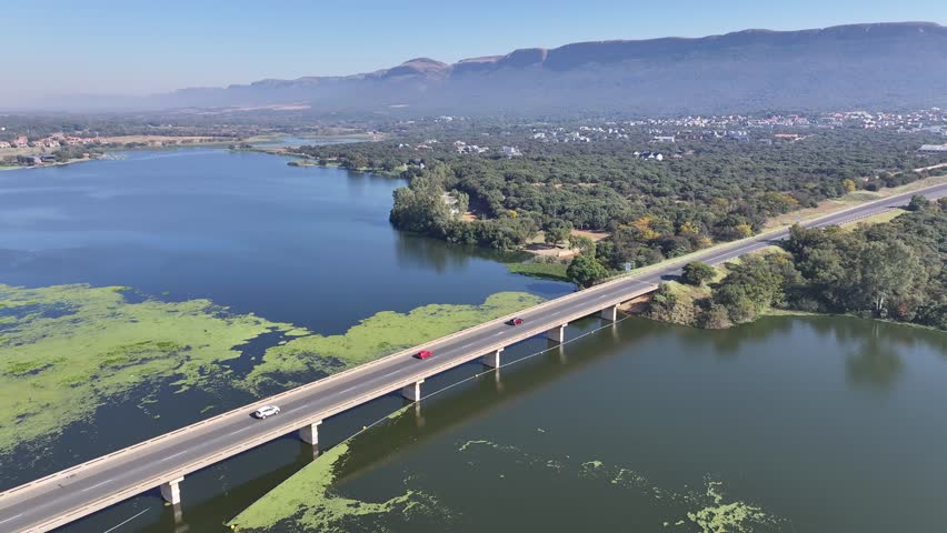 Magaliesberg Mountain At Hartbeespoort North West South Africa. Bridge Showcasing The Traffic Flowing Across In The City. Countryside Dramatic Clouds Rural Field. Landscapes Rural Panoramic.