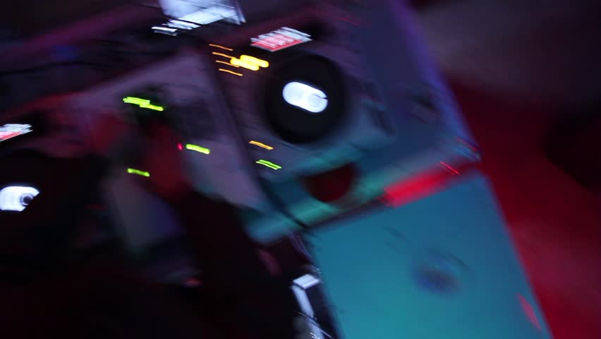 Dj's deck in night club. Low frame rate shot from the top.