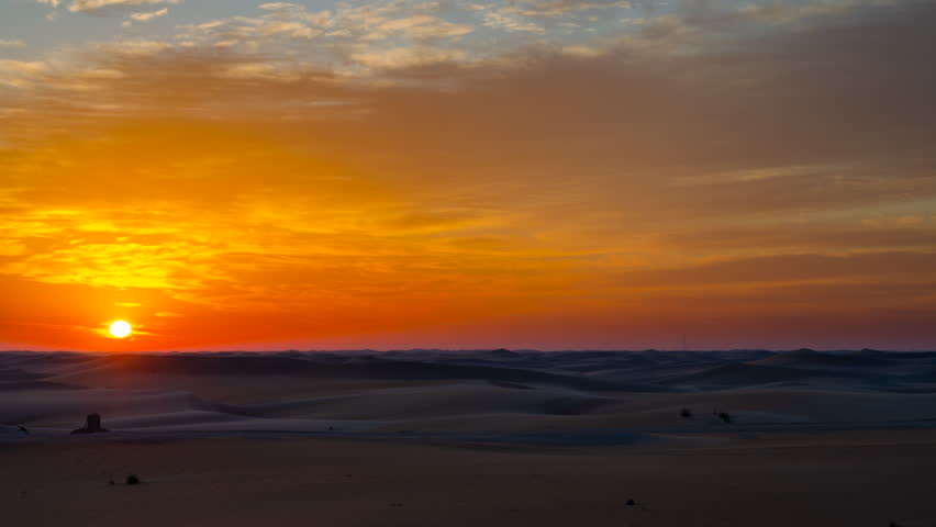 4K Time lapse of sunset sunrise with beautiful cloud color in the desert sand dune.