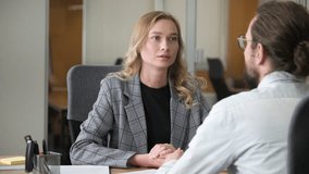 Confident businesswoman listen and having a serious conversation to her colleague in front of her desk. Man sitting an making a hand gestures. - Powered by Shutterstock - Get 15% off with code: PIKWIZARD15