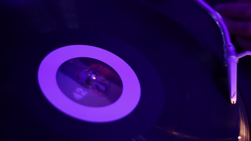 Rotating vinyl record on the turntable, platter is spinning.