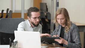 Two professionals collaborating on a project using different devices. Businesspeople engaged in problem-solving at a shared desk. - Powered by Shutterstock - Get 15% off with code: PIKWIZARD15