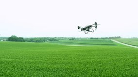 flying drone footage show an agricultural drone spraying chemicals over a lush green field. This video showcases the precision and efficiency of modern agricultural technology in crop management. - Powered by Shutterstock - Get 15% off with code: PIKWIZARD15
