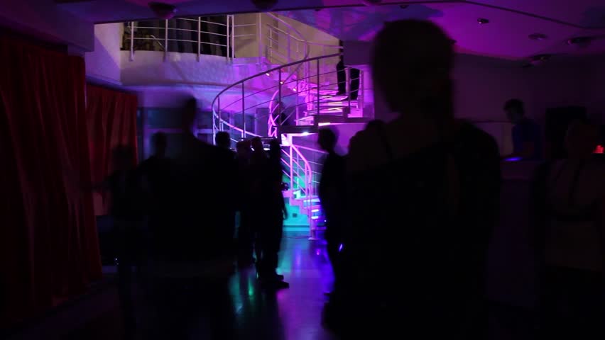 Time-lapse of people filling the night club, going up the stairs.