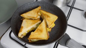 Woman hands cooking frying taking sandwiches from skillet on kitchen at home. Cook tasty meal, food, dish with white bread toasts. Ingredient recipe cuisine culinary. Homemade fast food preparing. - Powered by Shutterstock - Get 15% off with code: PIKWIZARD15