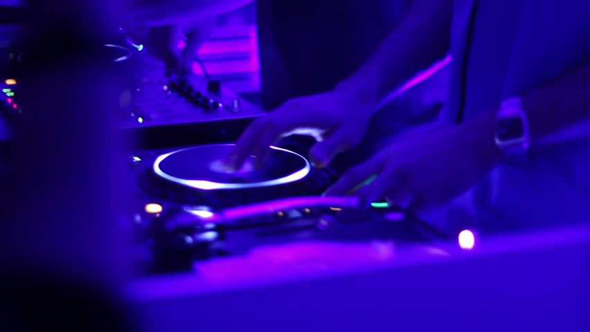 Two DJ playing simultaneously behind the deck