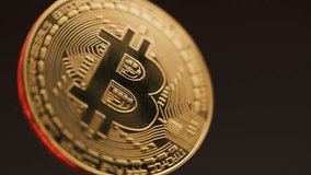 Close up of golden bitcoin coin spinning on the red background. Digital cryptocurrency virtual money. Blockchain modern technology. P2P bitcoin network. BTC logo. Mining and investment concept. - Powered by Shutterstock - Get 15% off with code: PIKWIZARD15