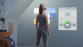 Athletic woman wearing AR headset starts online training. VR screen with displayed virtual coach and interface of fitness app with workout plan. Metaverse futuristic home gym with AI technologies. - Powered by Shutterstock - Get 15% off with code: PIKWIZARD15