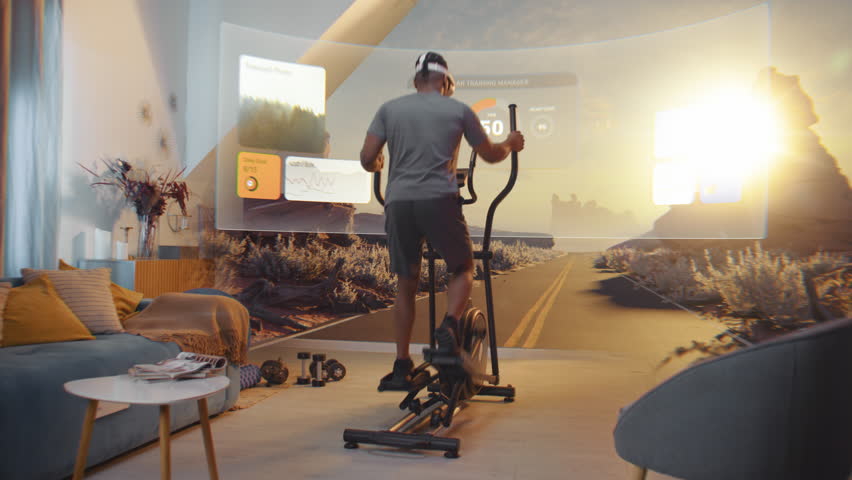 African American sportsman wearing AR headset trains on orbitrek. Virtual screen shows landscape and fitness application interface with timer and health care statistics. Metaverse futuristic home gym. - Powered by Shutterstock - Get 15% off with code: PIKWIZARD15