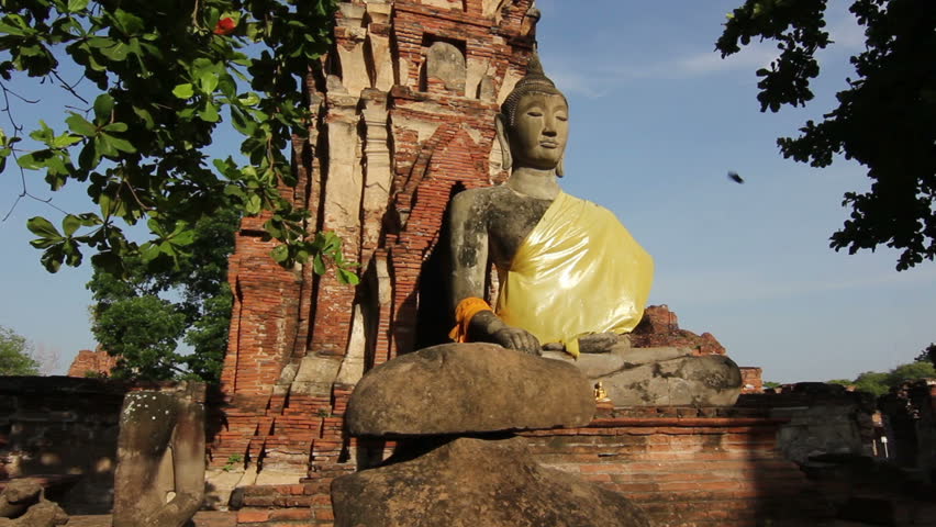Dolly shot of Buddha sitting at ancient temple Ayutthaya Thailand