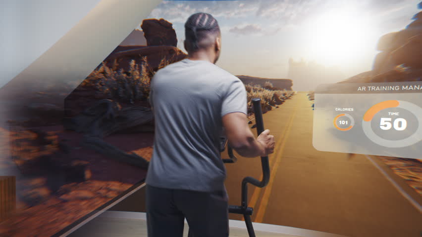 African American athletic man in virtual reality headset exercises on orbitrek. VR screen shows landscape and AR training manager with timer and health care statistics. Metaverse futuristic home gym. - Powered by Shutterstock - Get 15% off with code: PIKWIZARD15