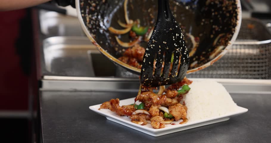 Cooking teriyaki chicken with rice, street food style. panning shot of Japanese food rice serves with chicken in Teriyaki sauce