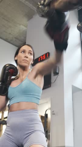 Personal trainer doing mitts with a female boxer