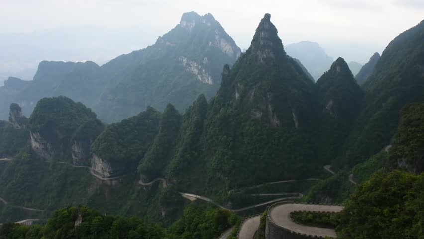 View landscape range mountain and road 99 curve turn for chinese people travelers travel visit Tianmen Shan cave or Heaven Gate in Tianmen Mountain National Forest Park at Zhangjiajie in Hunan China