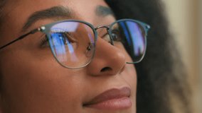 Close up female face woman African American girl in eyeglasses looking away glasses reflection smile calm gen z ethnic student business lady businesswoman thoughtful think dream health medicine beauty - Powered by Shutterstock - Get 15% off with code: PIKWIZARD15