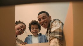 POV point of view inside box African American family parents little boy child open unpacking cardboard parcel happy joyful kid surprise buy teddy bear toy birthday present shopping delivery moving day - Powered by Shutterstock - Get 15% off with code: PIKWIZARD15