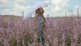 Little girl with a lace parasol on meadow
