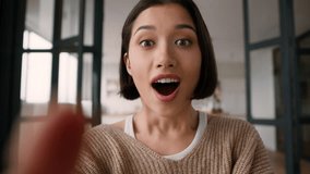 Point of view POV webcam mobile phone happy amazed excited girl Hispanic latin woman astonish wonder shock emotions read good news online app win typing message fingers touch screen display smartphone - Powered by Shutterstock - Get 15% off with code: PIKWIZARD15