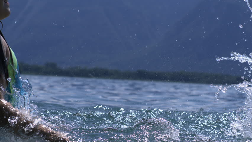 Big splash of water in lake, high-speed slow-motion capture, dynamic water movement, refreshing outdoor activity, summer fun, playful energy, serene nature background